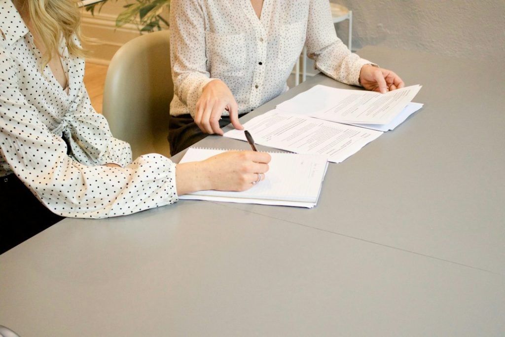 Professionals reviewing grant management documents