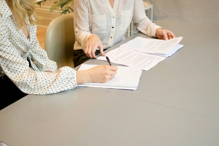 Professionals reviewing grant management documents